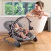 A woman is taking a bath while her baby is in a bouncer next to the tub. Produktbild-Vorschau