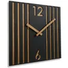 A square, modern wall clock with a black face and wooden slats. The clock has wooden hands and the numbers 12 and 6 are cut out of the face. Anteprima dell’immagine prodotto