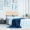 A bedroom scene with a bed, headboard, and decorative items. Produktbild-Vorschau