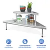 A two-tiered corner shelf unit made of stainless steel, displaying various kitchen items like bowls, jars, and a plant. Produktbild-Vorschau