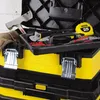 A close-up view of an open yellow and black Stanley toolbox filled with various tools. Voir les images du produit
