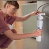 A woman is installing a water filter cartridge. Anteprima dell’immagine prodotto