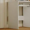 A close-up view of the side panel and interior shelf of a white modern computer desk. Podgląd zdjęcia produktu