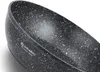 A close-up view of the speckled interior of a black pot or pan. Produktbild-Vorschau