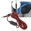 A close-up of a red and black braided headphone cable with a volume control, connected to a pair of black and blue headphones. Podgląd zdjęcia produktu