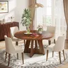 A dining room scene with a round wooden table and four chairs, set on a patterned rug. Podgląd zdjęcia produktu