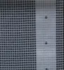 A close-up view of a white Leno tarp with a grid pattern and three circular holes. Náhľad obrázku produktu