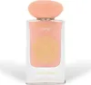 A perfume bottle with a peach-colored cap and a pink label with gold decorative elements. Voir les images du produit