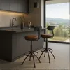 A modern kitchen with a view of a landscape, featuring two bar stools. Voir les images du produit