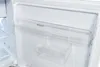 Interior of a white refrigerator with clear plastic shelves. Produktbild-Vorschau