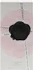 The image shows the packaging of a perfume bottle with a floral design and a wax seal. Anteprima dell’immagine prodotto