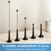 A row of five antennas of varying heights, with a white mug in the background. Produktbild-Vorschau