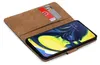 A brown book-style phone case with two cards inserted, showing a smartphone screen with a colorful wallpaper. Anteprima dell’immagine prodotto