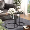 A living room setting with a leather couch, plants, and two round coffee tables. Náhľad obrázku produktu