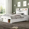 A white bed with storage drawers and a headboard with shelves is shown in a bedroom setting. Podgląd zdjęcia produktu