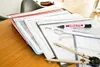 A desk with several folders and art supplies, including a marker and a compass. Produktbild-Vorschau