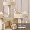 A multi-level cat tree with scratching posts and hanging toys, set against a light pink, vertically striped background. Podgląd zdjęcia produktu