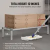 A shelf with boxes on it, and a mop on the floor. Produktbild-Vorschau