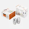 Two Gigaset baby monitor boxes and two baby monitor units are displayed on a light gray surface. Produktbild-Vorschau