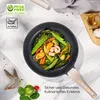 A frying pan filled with food is placed on a marble-like surface, with ingredients and oil bottle nearby. Anteprima dell’immagine prodotto