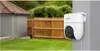 A white EZVIZ H8c 2K Dome IP security camera is mounted on a gray wall, overlooking a backyard with a green lawn, a wooden fence, and a small building with a red roof. Anteprima dell’immagine prodotto