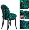 A chair with a tropical leaf-patterned cushion, shown from different angles and with close-ups of the cushion's ties. Produktbild-Vorschau