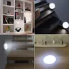 Collage of images showing LED night lights in different settings: on a bookshelf, on stairs, and on a wooden surface. Produktbild-Vorschau
