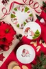 Christmas-themed plates and decorations arranged on a table. Anteprima dell’immagine prodotto