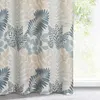 A close-up of a curtain with a leaf pattern, hanging near a window. Produktbild-Vorschau
