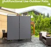 An outdoor patio scene with a gray fabric room divider set up, along with patio furniture. Voir les images du produit