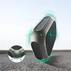 A close-up shot of a wireless charger with glowing green rings around it, suggesting its functionality. A smaller inset image shows a detailed view of the charger's base. Anteprima dell’immagine prodotto