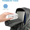 A hand is holding a white multi-plug adapter over an open backpack containing a laptop. Produktbild-Vorschau
