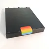 A black electronic device with a rainbow sticker on it, placed on a white surface. Náhled obrázku produktu