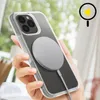A hand holding an iPhone with a clear case and a magnetic charger attached. Voir les images du produit