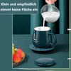 A person is pouring milk into a mug on a desk with a fruit bowl in the foreground. Produktbild-Vorschau