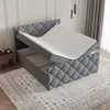 A bed with its mattress lifted to reveal storage underneath. Produktbild-Vorschau