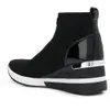 A black sock sneaker with a white sole and silver accents is shown from the side against a white background. Anteprima dell’immagine prodotto