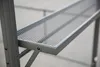 A close-up view of a gray metal shelf on a structure. Anteprima dell’immagine prodotto