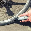 A person is using a Dremel tool to clean a bicycle wheel. Produktbild-Vorschau