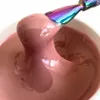 A close-up shot of a pink gel product being scooped out of a container with a rainbow-colored tool. Produktbild-Vorschau