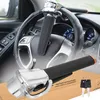 A steering wheel lock installed on a car's steering wheel, with a close-up of the lock and keys in the foreground. Náhľad obrázku produktu