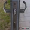 A close-up view of a door handle mechanism with two handles on either side. Náhled obrázku produktu