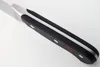 A close-up view of the handle and part of the blade of a knife. Voir les images du produit