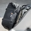 A black motorcycle luggage bag is attached to a rack. Produktbild-Vorschau