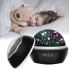 A child sleeping with a teddy bear next to a night sky projector. Voir les images du produit