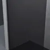 A corner of a modern shower enclosure with a black glass panel and gray concrete-like walls. Anteprima dell’immagine prodotto