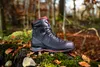 A black and red hiking boot is placed on a mossy rock in a forest setting with fallen leaves. Náhľad obrázku produktu