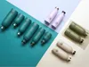 A collection of reusable water bottles arranged on a multi-colored background. Produktbild-Vorschau
