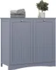 A gray laundry cabinet with two doors, topped with folded towels and a small potted plant. Produktbild-Vorschau