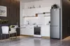 A modern kitchen with white cabinets, a silver refrigerator, and a small dining area. Náhľad obrázku produktu